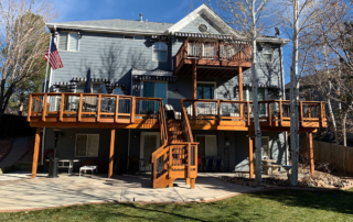 a multi-level custom wood deck, railings, stairs, and roof cover