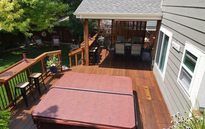 a custom raised wood deck with roof cover and spa