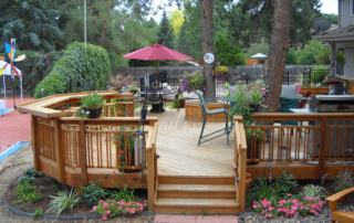 beautiful gardens surrounding a custom wood deck