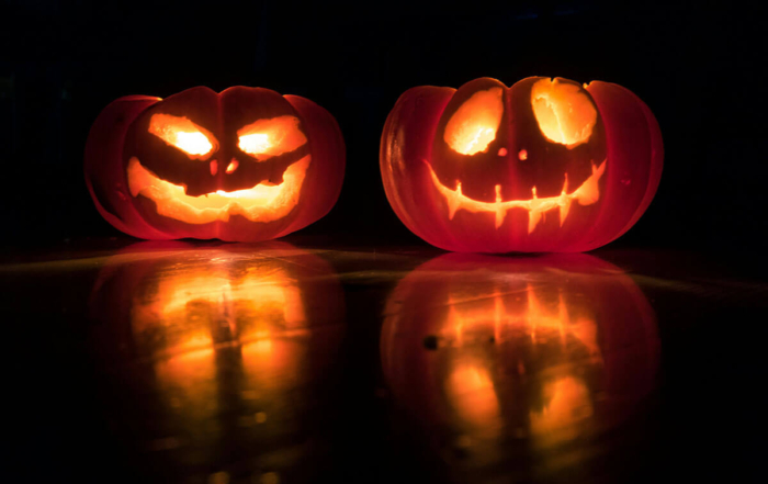 2 lit jack-o-lanterns in the dark