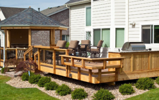 a custom backyard deck and railings with a gazebo on one end