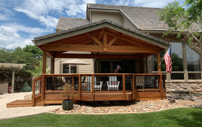 a custom roof covered wood deck with custom railings