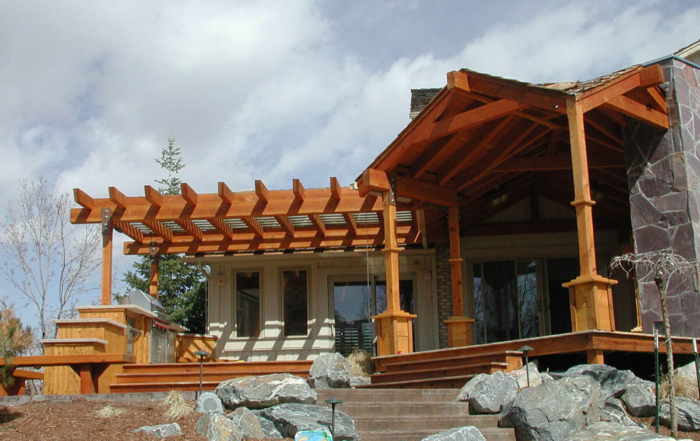 custom wood deck entry with a pergola