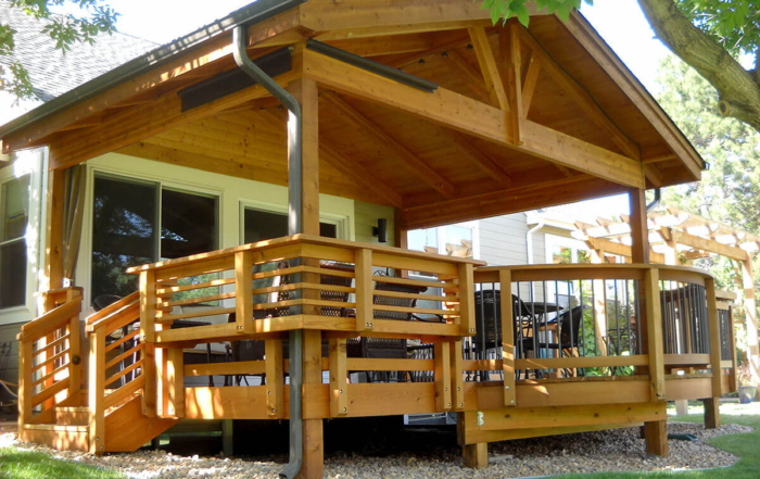 a custom wood deck, railings, and roof cover