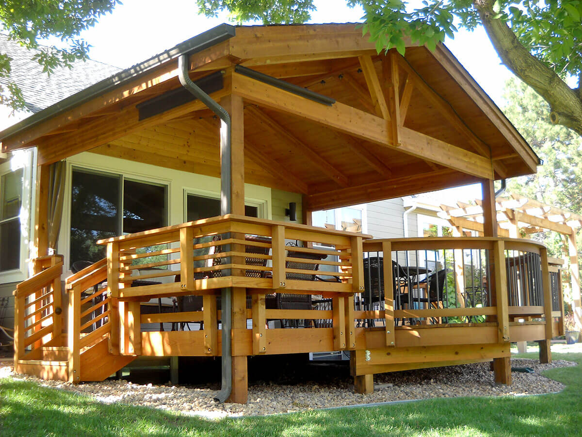 a custom wood deck, railings, and roof cover
