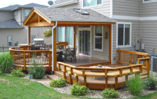 a custom back yard deck with a roof cover