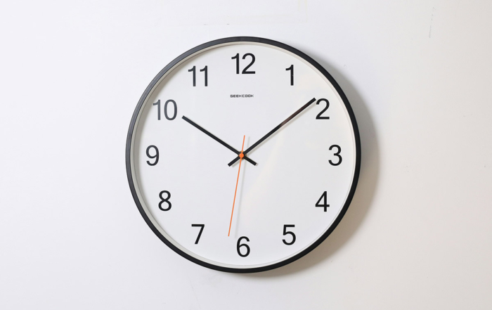 picture of a white clock hanging on a white wall