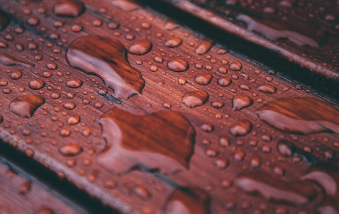 beads of water gathered on a freshly stained deck