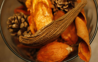 a bowl of harvest goods sitting on a table