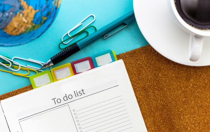 a desktop with an organizer and a cup of coffee