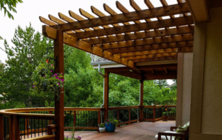 custom wood deck and railings with a pergola