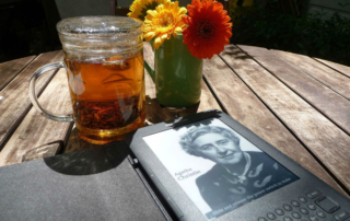 a glass of tea and a book on the table