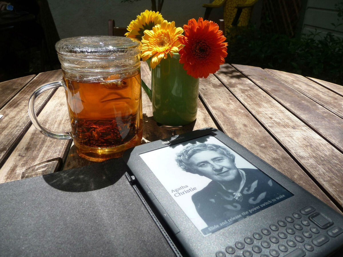 a glass of tea and a book on the table