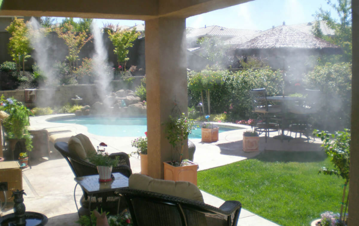 a covered patio with air misters running