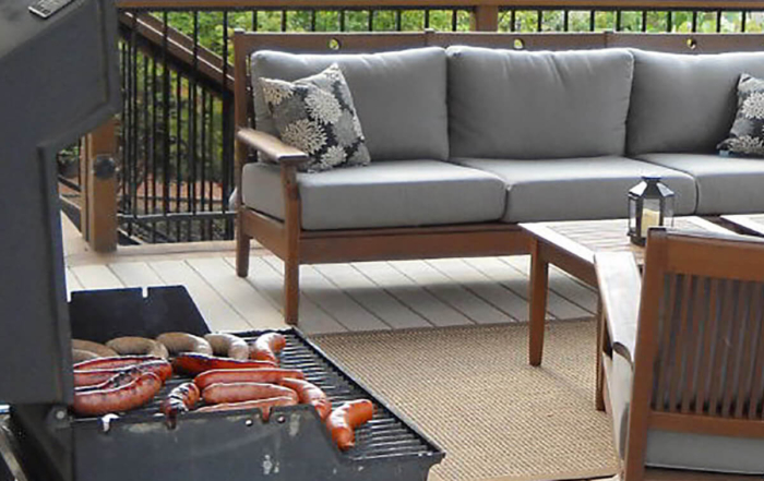 a loaded up grill on a custom wood deck