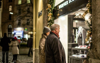 a couple window shopping during the holidays