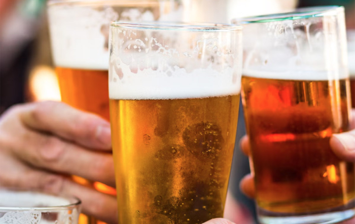 friends raising a cheers with glasses of beer