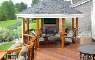 a gazebo with a tv at the end of a custom wood deck