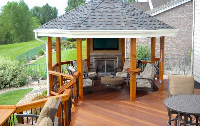 a gazebo with a tv at the end of a custom wood deck