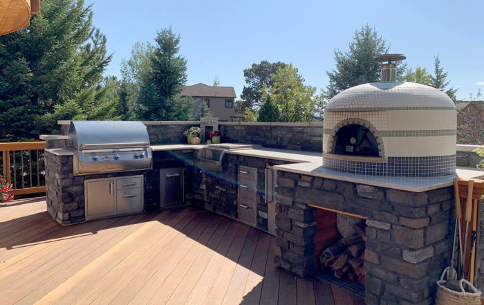 an outdoor kitchen built into a custom wood deck