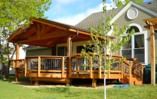 a custom raised wood deck and railing with a roof cover