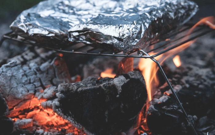 a campfire dinner over burning hot coals