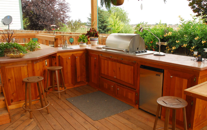 a custom wood deck with a built-in custom kitchen