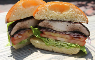 a portobello mushroom sandwich cut in half