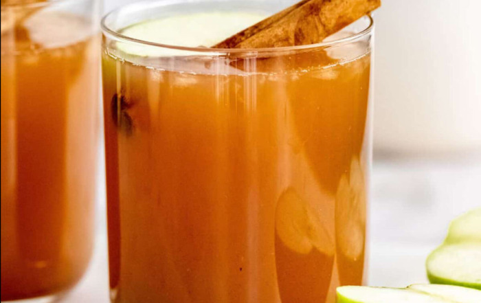 glasses of apple cider with cinnamon sticks