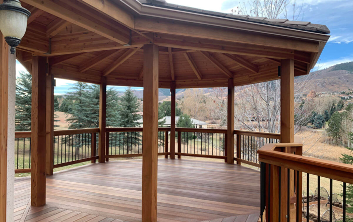 a roof covered custom wood deck and railing