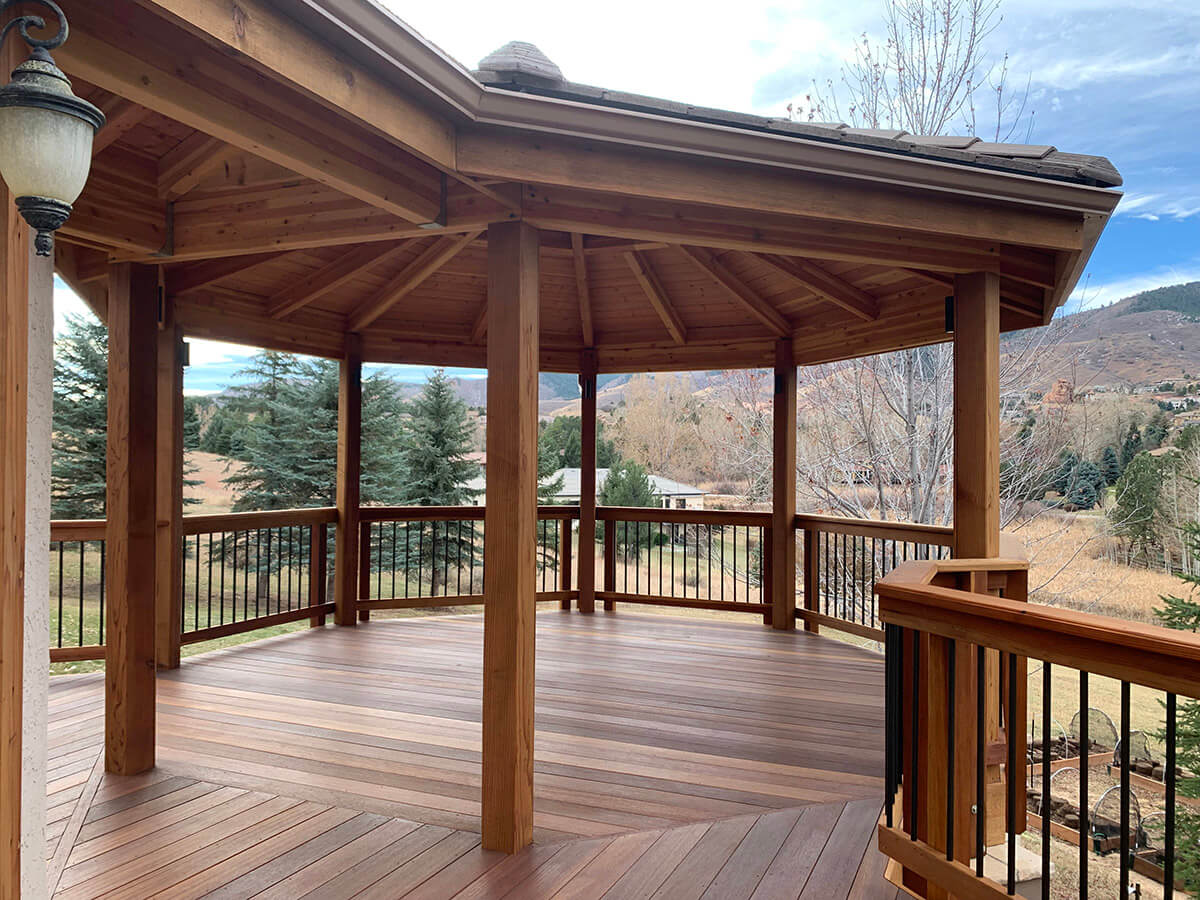 a roof covered custom wood deck and railing