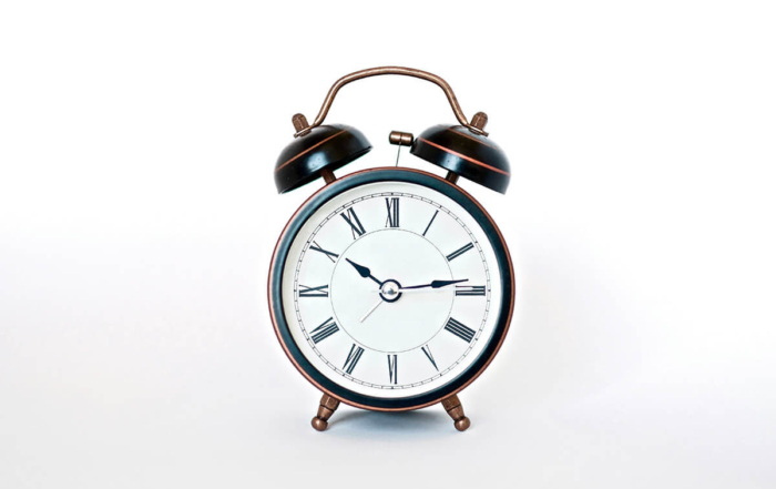 an alarm clock with roman numerals