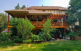 custom second-level wood deck with a roof cover