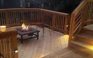 a fire pit burning on a custom wood deck