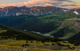 a beautiful view of a valley into the mountains