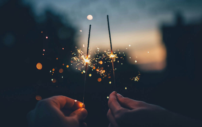 2 sparklers glowing in the dark