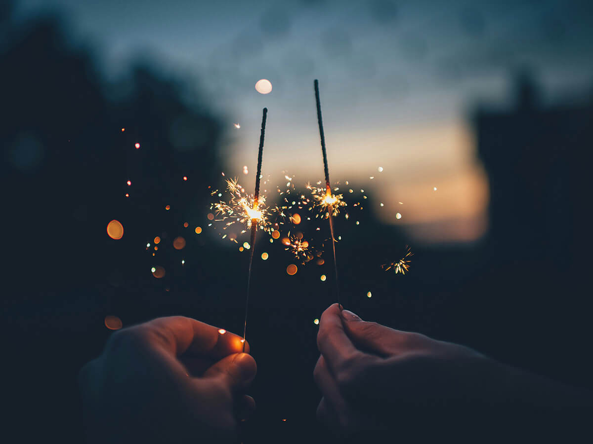 2 sparklers glowing in the dark