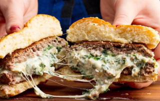 a gourmet burger splayed in half to show its goodness