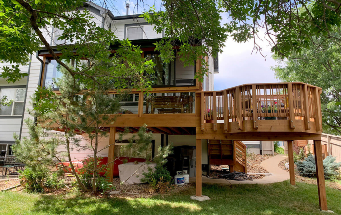 a second-story sunroom connected to a custom wood deck