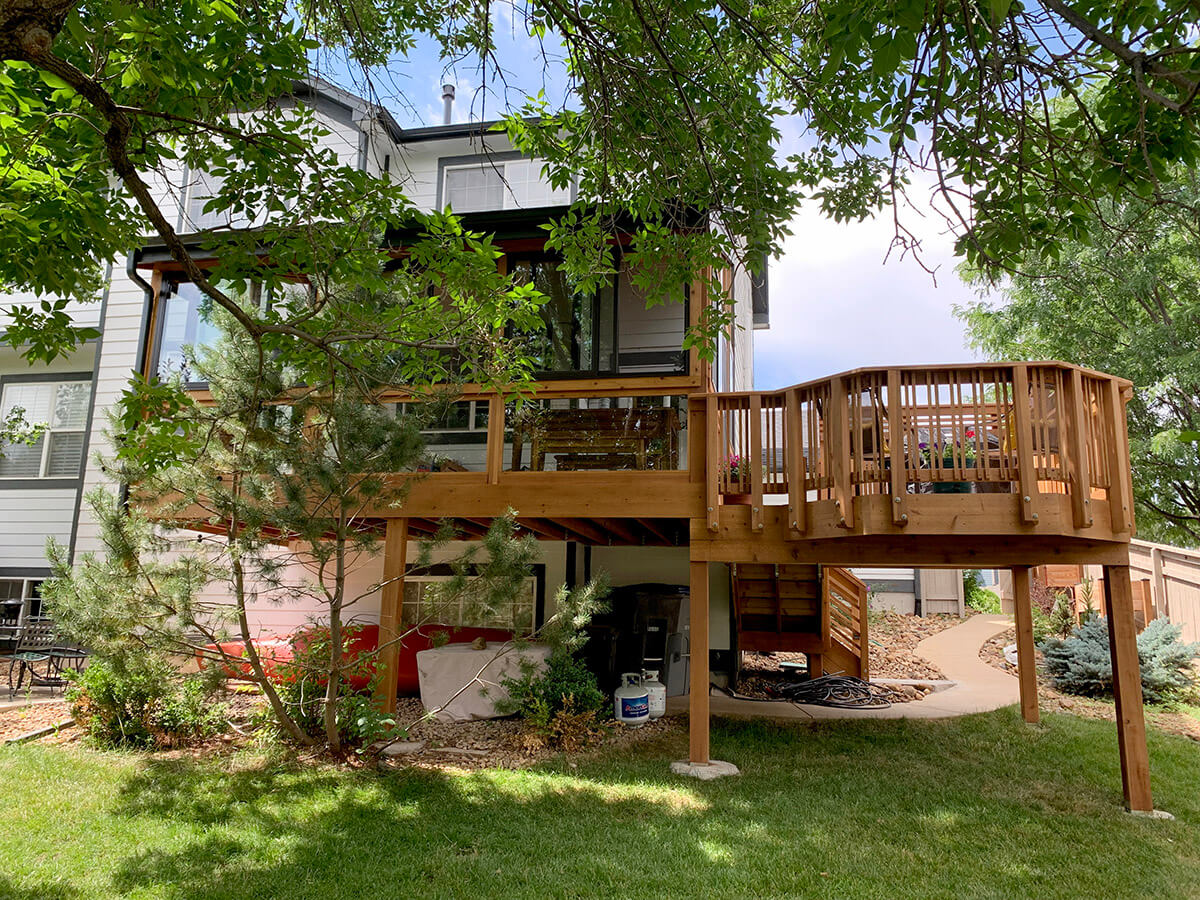 a second-story sunroom connected to a custom wood deck