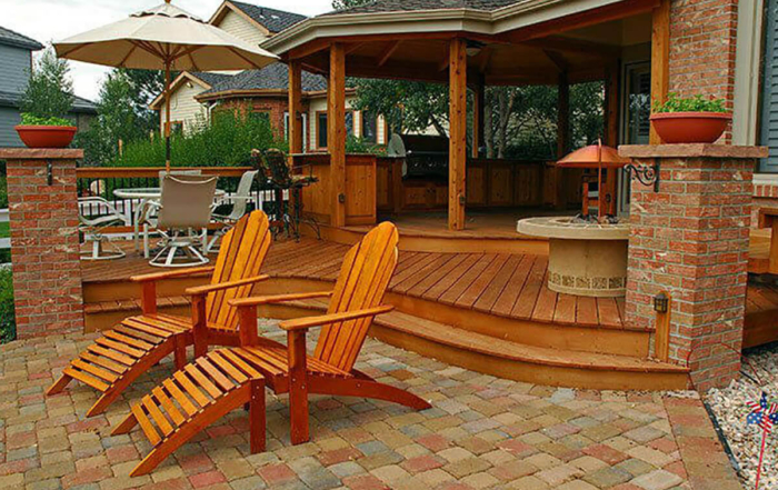 paver patio connected to a custom roof-covered wood deck