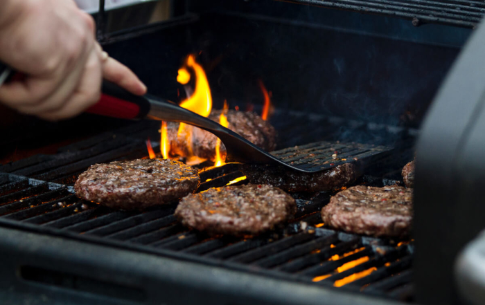 burgers on a flaming grill