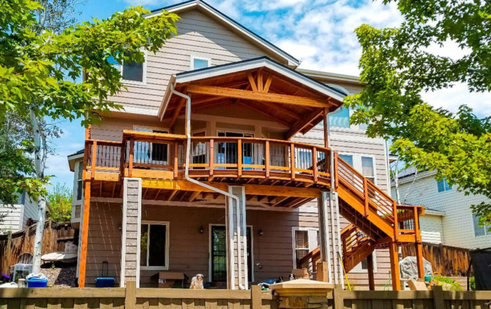 raised deck with a roof cover and custom staircase