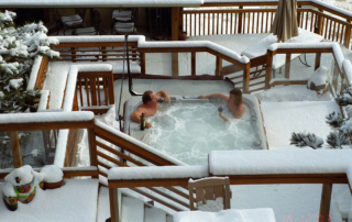 man and woman relaxing in a hottub on their deck