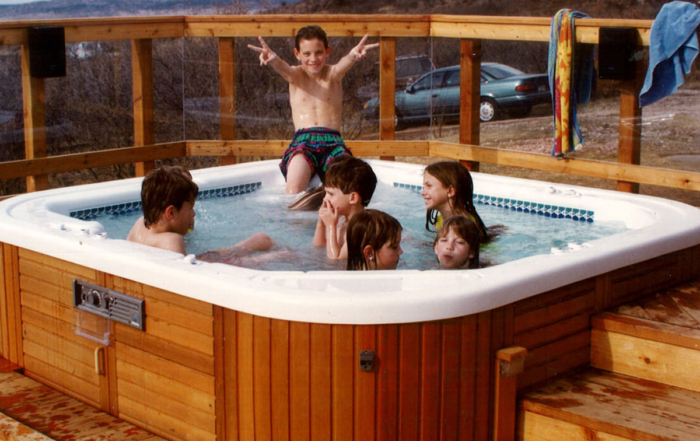 kids in a spa on a wood deck