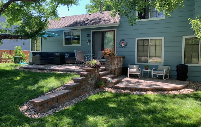 multi-level paver patio separated by a retaining wall