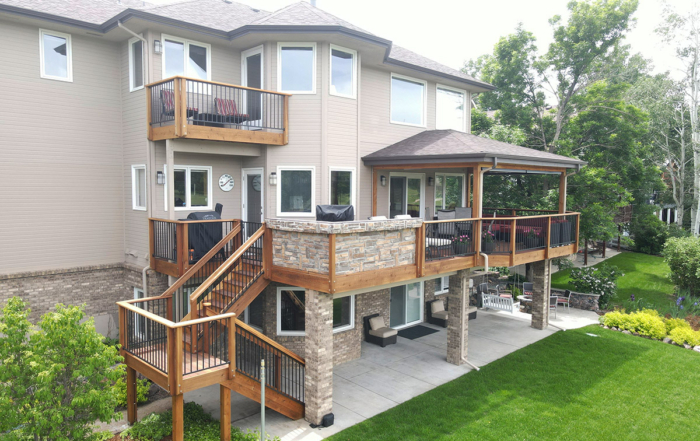 multi-level redwood deck with a roof cover