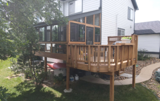 an elevated sunroom connected to a custom second story wood deck