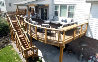 custom wood deck, railings and staircase with a roof cover