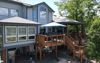 sunroom connected to a second story wood deck with roof cover